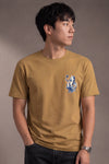Man wearing a custom faded mustard tee with a small chest print