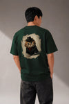 Man wearing a custom green boxy tee with a printed design