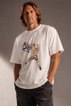 Man wearing a custom white boxy tee with a colorful print