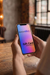 Hands holding a phone showing a NextGenVibez digital gift card
