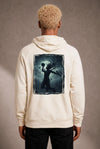 Man wearing a custom cream hoodie with a printed chest design