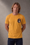 Man wearing a custom mustard tee with a small chest print