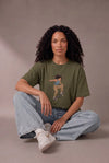 Woman wearing a custom faded green relaxed tee with a printed design