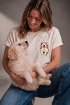 Woman wearing a custom cream tee with a pet print, holding her cat