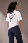 Woman wearing a custom white relaxed tee with a dog sketch print
