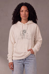 Woman wearing a custom cream hoodie with a printed design